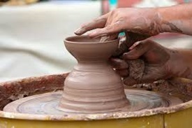 Hands shaping a piece of pottery